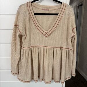 Cream V-Neck Peplum Knit Top with Rust Contrast Stitching